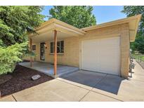 Charming brick home with a covered porch and attached one-car garage at 2236 S Osceola St, Denver, CO 80219
