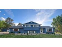 Charming two-story home with a manicured front yard and lovely flower boxes, showcasing curb appeal at 15945 Delta Ct, Brighton, CO 80603