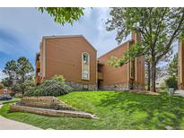 Beautifully landscaped condo building with a combination of wood and stone, nestled on a lush green lawn at 4285 S Salida Way # 17, Aurora, CO 80013