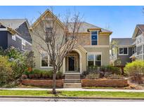 Charming two-story home featuring well-maintained landscaping and a welcoming entrance with a brick retaining wall at 9826 E 27Th Dr, Denver, CO 80238