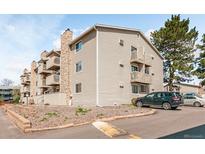 Angled exterior view of a multi-story apartment building featuring stone accents and balconies at 381 S Ames St # E305, Lakewood, CO 80226