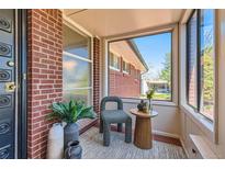 Charming sunroom featuring large windows and a cozy chair for relaxing and enjoying the view at 5975 S Milwaukee Way, Centennial, CO 80121
