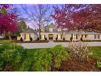 Charming brick home features a well-manicured front yard and a large driveway, perfect for Gathering living at 38 Sedgwick Dr, Cherry Hills Village, CO 80113