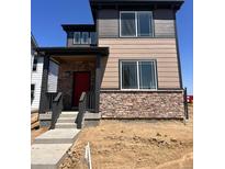 Charming two-story home with red front door, stone accents, and a covered porch at 5454 N Elk St, Aurora, CO 80019
