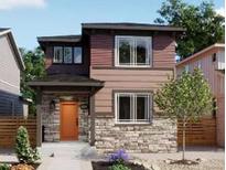 Charming two-story home with stone accents, a cozy front porch and colorful orange front door at 5454 S Elk Way, Aurora, CO 80016