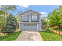 Charming two-story home with a well-manicured lawn and attached two-car garage, offering curb appeal at 6650 Stagecoach Ave, Firestone, CO 80504