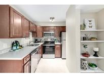 Well-lit kitchen features stainless steel appliances, spacious countertops, and sleek cabinetry at 5300 E Cherry Creek South Dr # 324, Denver, CO 80246