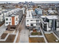 Modern townhomes with rooftop decks and city skyline views in a vibrant urban neighborhood at 1810 Julian St # 105, Denver, CO 80204