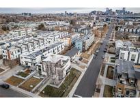 Aerial view of modern townhouses with city skyline in background at 1810 Julian St # 105, Denver, CO 80204