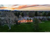 Expansive estate with manicured lawn and outdoor living spaces at twilight at 18 Club Ln, Littleton, CO 80123