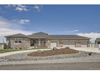 Charming home featuring stone accents, a three-car garage, and a meticulously landscaped front yard at 8625 E 125Th Ct, Thornton, CO 80602