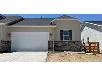 Charming single-Gathering home boasts a two-car garage and stone accents on the exterior, creating a modern look at 3381 N Denali St, Aurora, CO 80019