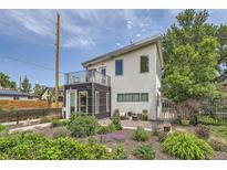 Contemporary home with modern architecture, balcony, landscaped yard and a metal fence at 3850 Vallejo St, Denver, CO 80211