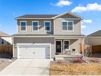 Inviting two-story home with a well-maintained lawn, attached garage, and neutral siding at 2489 Alto St, Fort Lupton, CO 80621