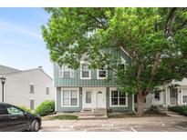 Charming townhome exterior featuring a mature shade tree and well-maintained landscaping at 10298 W Dartmouth Ave, Lakewood, CO 80227
