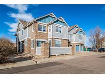 Attractive townhome featuring a stone and siding exterior with a two-car garage and well-kept landscaping at 23414 E Dorado Pl # A, Aurora, CO 80016
