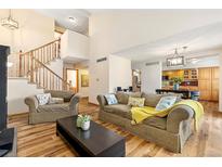 Inviting living room features hardwood floors, comfortable seating, and abundant natural light at 2650 S Vaughn Way # B, Aurora, CO 80014