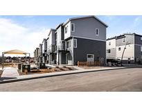 Modern townhome exterior with two-tone siding and a small front yard at 2676 W 68Th Ave, Denver, CO 80221