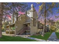 Attractive exterior view of a modern two-story condo with a lush green lawn and trees in a quiet neighborhood at 5300 E Cherry Creek South Dr # 620, Denver, CO 80246