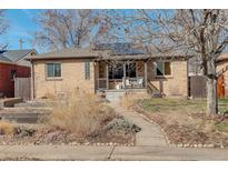 Charming brick home with a cozy front porch and well-maintained landscaping at 2045 Jamaica St, Aurora, CO 80010