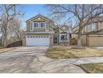 Charming two-story home with a well-maintained lawn and a two-car garage in a quiet neighborhood at 19357 E 40Th Ave, Denver, CO 80249