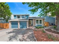 Charming two-story home with blue siding, brick accents, two-car garage, and well-maintained landscaping at 7226 S Eagles Nest Cir, Littleton, CO 80127