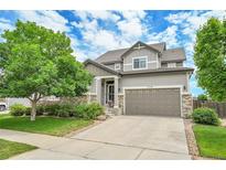 Charming two-story home featuring a well-manicured lawn, neutral siding and a convenient two-car garage at 5778 S Duquesne Ct, Aurora, CO 80016