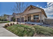 Charming single-Gathering home with a covered front porch and inviting curb appeal on a sunny day at 4032 Donnington Cir, Castle Rock, CO 80104