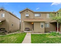 Charming townhome featuring a cozy front porch and well-maintained lawn at 1061 S Yampa St # C, Aurora, CO 80017