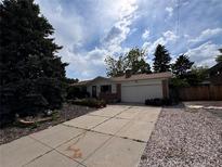 Charming single Gathering home with attached garage and long concrete driveway at 1843 S Urban Way, Lakewood, CO 80228