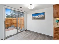 Dining area with sliding glass doors leading to a private outdoor patio at 7999 Chase Cir # 31, Arvada, CO 80003