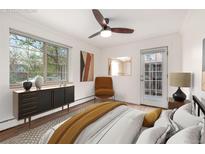 Bright bedroom with modern furnishings, stylish decor, and natural light from large windows at 70 N Grant St # 10, Denver, CO 80203