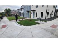 Modern townhome with fresh landscaping, bike rack, and light-colored exterior paint scheme at 1295 Utica St, Denver, CO 80204