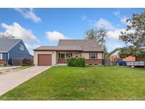 Charming single-story home featuring a well-maintained lawn, attached garage, and beautiful blue sky at 3270 W 92Nd Pl, Westminster, CO 80031