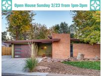 Charming single-story home with brick exterior, attached garage, and inviting front yard with lush greenery at 5450 Mohawk Rd, Littleton, CO 80123