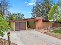 Charming mid-century home with brick accents, unique garage, and landscaped front yard at 5450 Mohawk Rd, Littleton, CO 80123