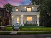 Stunning modern two-story home featuring a covered front porch and second-story balcony with black metal railings at 332 S Franklin St, Denver, CO 80209