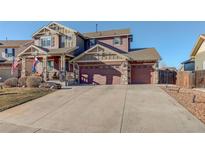 Two-story home featuring a wide driveway and a charming craftsman style design at 10265 Olathe St, Commerce City, CO 80022