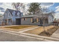 Charming single-story home with gray siding, complemented by natural wood-toned shutters, and a cozy gravel front yard at 921 Meade St, Denver, CO 80204