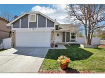 Charming home featuring a two-car garage, well-manicured lawn, and appealing landscaping at 1292 W 133Rd Cir, Westminster, CO 80234