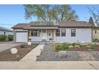 Charming home with a well-maintained front yard, featuring drought-tolerant landscaping and solar panels at 1655 S Lowell Blvd, Denver, CO 80219
