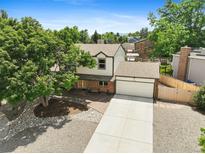 Charming two-story home with a large front yard, mature tree, and a two-car garage at 10378 W Weaver Ave, Littleton, CO 80127