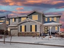 Two-story house with gray siding, stone accents, and a covered porch at 27750 E Lakeview Dr, Aurora, CO 80016