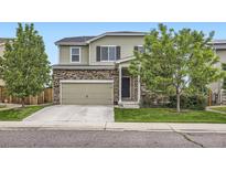 Charming two-story home with stone accents, lush landscaping, and a two-car garage at 942 Wagon Bend Rd, Berthoud, CO 80513