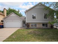 Charming two-story home features a well-maintained lawn and attached two-car garage at 12632 James Ct, Broomfield, CO 80020