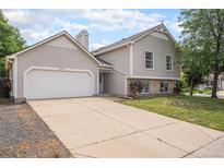 Charming two-story home with a spacious driveway and a well-maintained front yard at 12632 James Ct, Broomfield, CO 80020