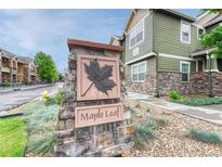 Attractive stone sign with a maple leaf identifies the Maple Leaf community and its charming exteriors at 7140 Simms St # 102, Arvada, CO 80004