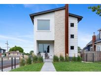 Modern two-story home with stone accents, a well-manicured lawn, and inviting front porch at 5101 Quitman St, Denver, CO 80212
