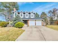 Charming two-story home with a well-manicured lawn, mature trees, and a two-car garage at 3269 W 101St Cir, Westminster, CO 80031