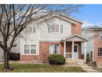 Charming two-story home featuring a combination of brick and siding and a cozy front porch at 10700 Kimblewyck Cir # 225, Northglenn, CO 80233